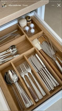 an open drawer with silverware in it