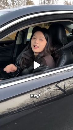 a woman sitting in the driver's seat of a car