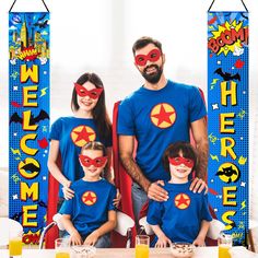 a man and two children wearing superhero shirts