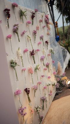 flowers are arranged on the side of a wall