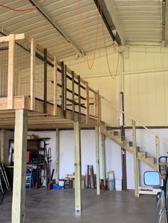 the inside of a garage with some stairs and railings on it's sides