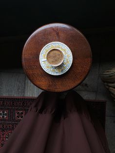 a cup of coffee is sitting on top of a wooden table in front of a rug