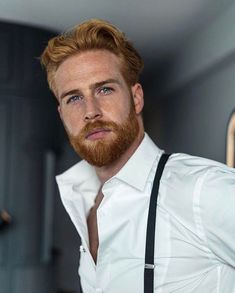 a man with red hair and beard wearing suspenders