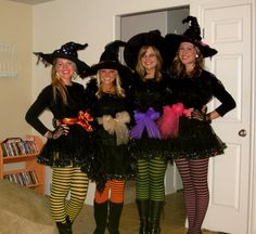 three women dressed up in costumes posing for the camera