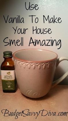 a white cup sitting on top of a counter next to a bottle of essential oils