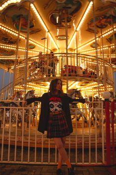 a woman standing in front of a merry go round