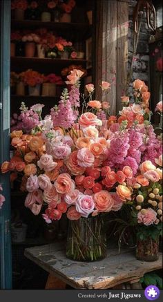 a vase filled with lots of pink and orange flowers