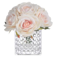 a vase filled with white roses on top of a table