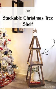 a wooden christmas tree shelf sitting in front of a white wall with the words diy stackable christmas tree shelf