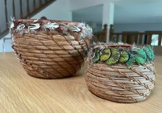 two baskets sitting on top of a wooden table