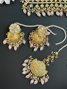 This lightweight and dainty set in thapa kundan or multani work is made of high quality gold plating and has gorgeous pink crystal drops that have an ombre finish. The colors are super unique and pastel so that they can go with any outfit whether its a saree or lehenga! and can be worn separately for a simple look. This lightweight and elegant necklace is perfect for any bridesmaid, bride, sangeet or any occasion or event as a gift for any occasion as any one who loves jewelry will love this sta Pink Chandbali Set With Mirror Work, Pink Kundan Traditional Wear For Diwali, Bollywood Style Pink Traditional Wear With Kundan, Pink Kundan Wedding Set, Pink Traditional Wear With Mirror Work In Kundan, Gold Jewelry With Mirror Work For Eid, Pink Stone Work Tikka As Gift, Gold Stone Work Sets For Eid, Gold Sets With Stone Work For Eid