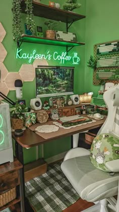 a desk with a computer, keyboard and mouse on it in front of a green wall