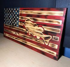 an american flag made out of wood with the fish symbol on it's side