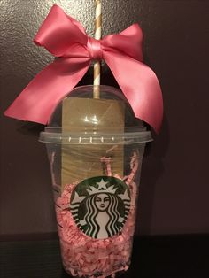 a starbucks cup with pink candy in it