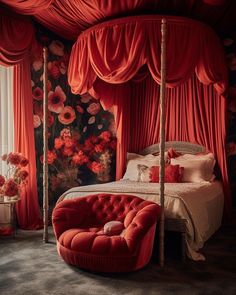 a bedroom with red drapes and flowers on the wall, bed in front of window