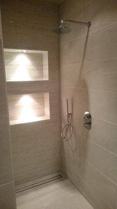 a bathroom with a shower head and window