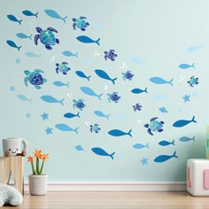 a blue wall with fish and turtle decals on it