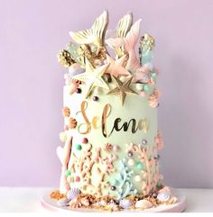 there is a cake decorated with seashells and starfish