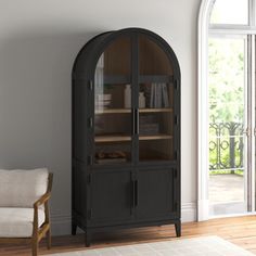 a living room with a chair and bookcase in it