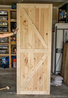 a man is working on a sliding door in his garage with the words sliding interior barn doors