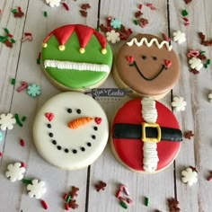 three decorated cookies sitting on top of a table