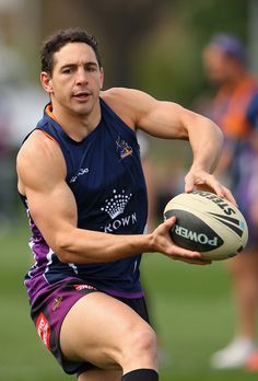 a man holding a rugby ball in his right hand