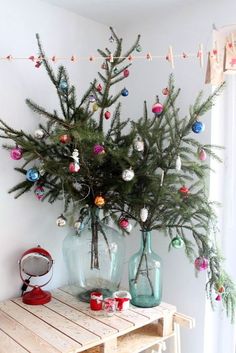 there are pictures of christmas trees in vases on the wall and at the table