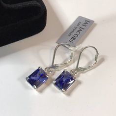 Beautiful Emerald Cut Tanzanite* & Sterling Silver Leverback Earrings * Emerald Cut Tanzanite* measure 8mm x 6mm each * 3cts total gemstone weight * Solid Sterling Silver * Measure 1 inch Long overall * Leverback fastening Hallmarked & Gift Ready! Matching Pendant Necklace and/or Ring also Available *Tanzanite is one of very few gemstones that cannot be grown in a Lab, however, these Laboratory Grown Simulate Stones are optically identical to a natural Tanzanite in color and are just as Trillion Cut Earrings, December Gift, Luxury Diamond Jewelry, White Sapphire Earrings, Green Amethyst Earrings, Pink Sapphire Earrings, Earrings Emerald, Tanzanite Earrings, Fine Art Jewelry