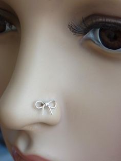 a close up of a mannequin's nose with a bow on it