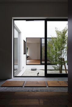 an empty room with wooden floors and sliding glass doors that lead to the outside patio