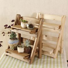 a wooden shelf with potted plants on it