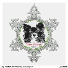 a christmas ornament with a dog on it's face and snowflakes