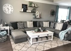 a living room filled with furniture and a clock on the wall