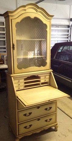 an old fashioned desk has been painted yellow and is in the process of being restored