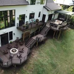 an aerial view of a house with decking and patio furniture