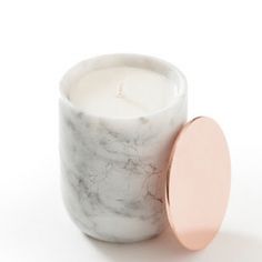 a marble candle holder with a pink lid