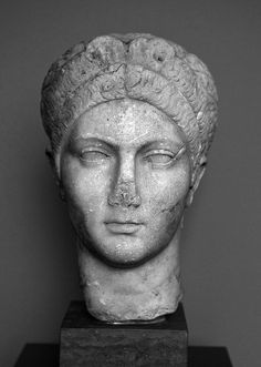 the head of a statue is shown in black and white, with its eyes closed