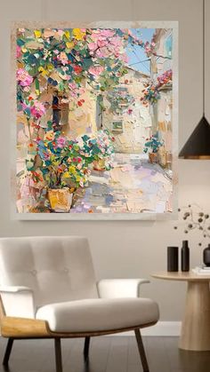 a living room with a white chair and painting on the wall