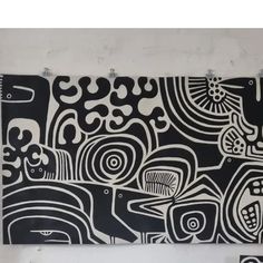 two black and white paintings hanging on the wall