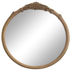 a round mirror with an ornate wooden frame