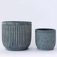 two ceramic cups sitting next to each other