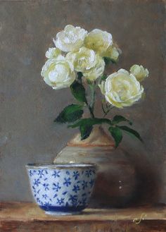 a painting of white roses in a blue and white vase on a wooden table top