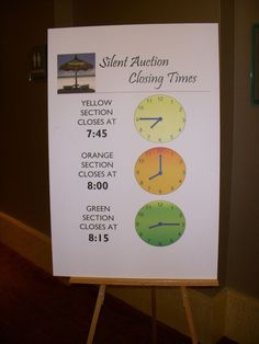 a sign with three clocks on it in front of a wall that says silent auction closing times