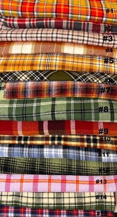 many different plaid fabrics are stacked on top of each other