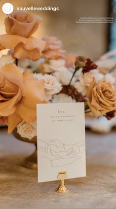 a close up of a card on a table with flowers