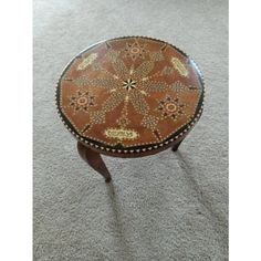 a wooden table sitting on top of a carpeted floor