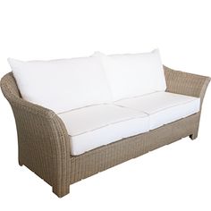 a wicker couch with two white pillows on the top and bottom cushions, sitting against a white background