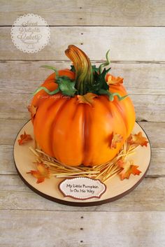 a pumpkin cake on a plate with leaves