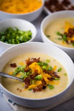 three bowls filled with soup sitting on top of a table