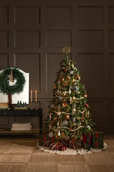 a decorated christmas tree in front of a mirror